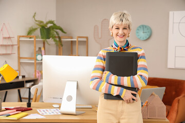 Female graphic designer with tablet in office