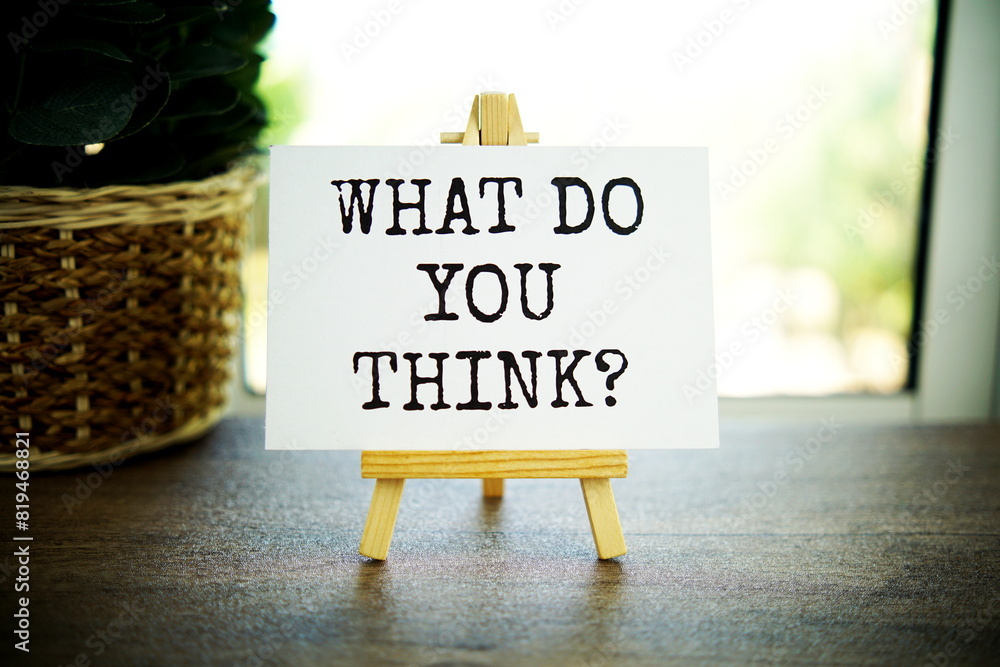 Poster what do you think? text message on paper card with wooden easel