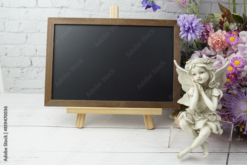 Poster empty chalkboard mock up space for text message with flower bouquet and home decorations on wooden b