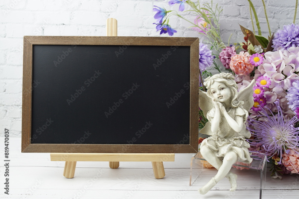Poster empty chalkboard mock up space for text message with flower bouquet and home decorations on wooden b