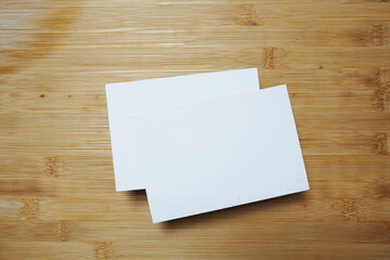 Top view Empty card mockup on wooden background