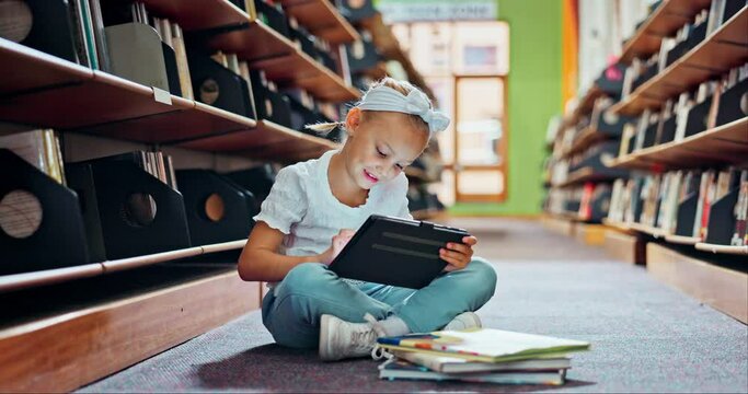 Girl, child and tablet with books in library for education, growth and development with online course. Kid, digital touchscreen and e learning for language, assessment and smile for info at school