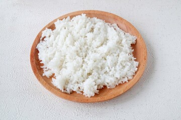 cooked white rice on wooden plate