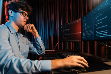 IT developer thinking online software development information coding on pc screen at side view,...