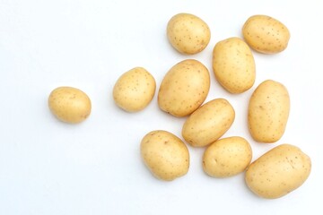 Potatoes scattered, on a white table, vegetarianism, food, vegetables, free space, place for text, top view, background