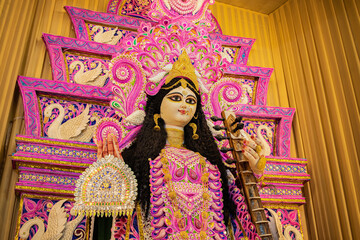 goddess saraswati holding veena during saraswati puja festival in india. The hindu female deity symbolizes education, music, art and culture.