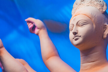 idol of goddess durga during durga puja festival. The unfinished idol is made of clay being sculpted.