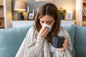 Sickness, seasonal virus problem concept. Woman being sick having flu lying on sofa. Sick woman...