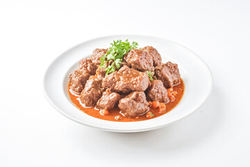 Fototapeta premium Beef Stew with Carrots and Parsley on White Background
