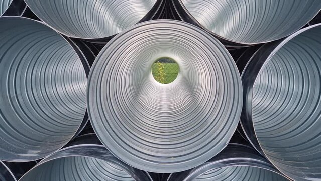 stainless steel, clay flexible chimney insert. Single shell gas liner. It ensures a clear passage of smoke and flue gases. a pile of bran nested on top of each other in a circular pattern shiny sheet 