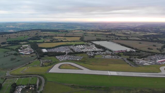 Aerial footage of the famous Leeds and Bradford airport located in the Yeadon area of West Yorkshire in the UK, typical British airport showing the runway and houses and roads around the airport