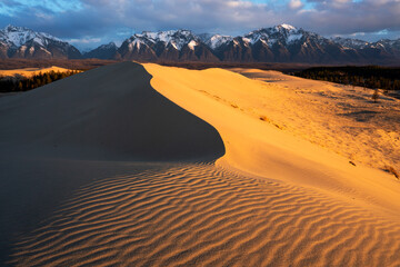 Chara Sands, Kodar nature reserve.Ripples in the sand dunes are highlighted by the warm glow of a...