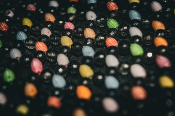 colorful mote berry beads attached to a women's bag