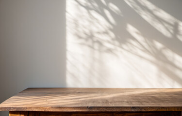 Product placement. wooden table and wall with tree shadow pattern, aesthetic contrast, items display, polished wood tabletop