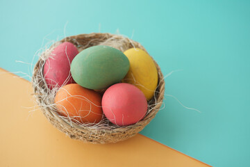 easter concept with multi color egg on pink background.