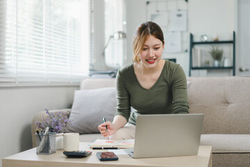 Young businesswoman working from home with laptop and documents. Work life balance concept