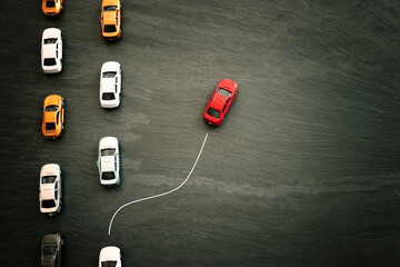Concept image of challenge and teamwork. Red car leading the group