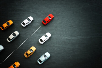 Concept image of challenge and teamwork. Red car leading the group