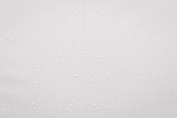 Rain drop on white fabric background, clear drop on white fabric pattern background