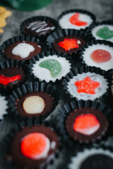 Stack of vegan chocolate cups with caramel on white tabletop. Homemade vegetarian chocolate caramel cups. Ideas and recipes for healthy sweets and dessert. Selective focus. Copy space for text.