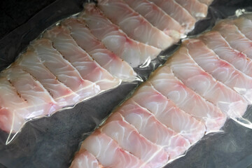 Fresh grouper fish fillets in vacuum package for delicious menu, perfect for a healthy and easy...