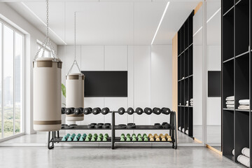 Home sport room interior with dumbbell rack and punching bag, tv and window