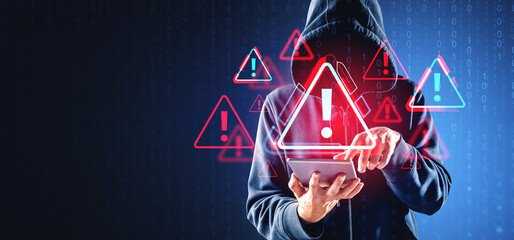 A person in a hoodie using a tablet, with warning symbols and bi