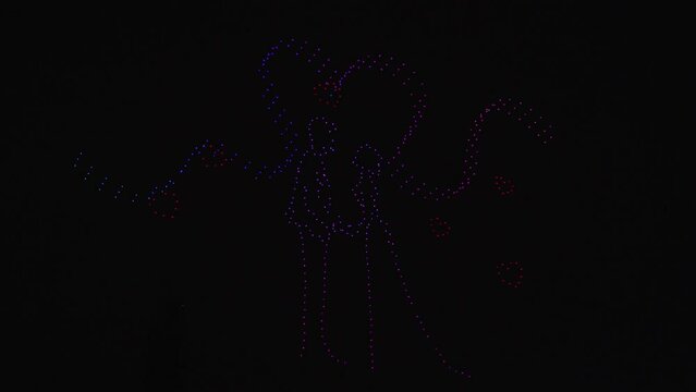 Thousands of drones perform a flying show to form a love proposal between a man and a woman