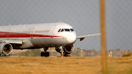Airplane on the runway before takeoff at sunrise or sunset