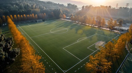 Vibrant Autumn Soccer Field Bathed in Warm Sunset Glow Surrounded by Lush Foliage