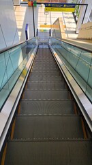 an escalator in an airport with a sign that says  escalator