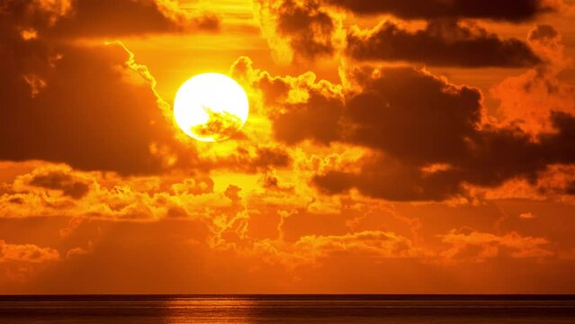 Beautiful sunset in orange sky over ocean water. Timelapse.