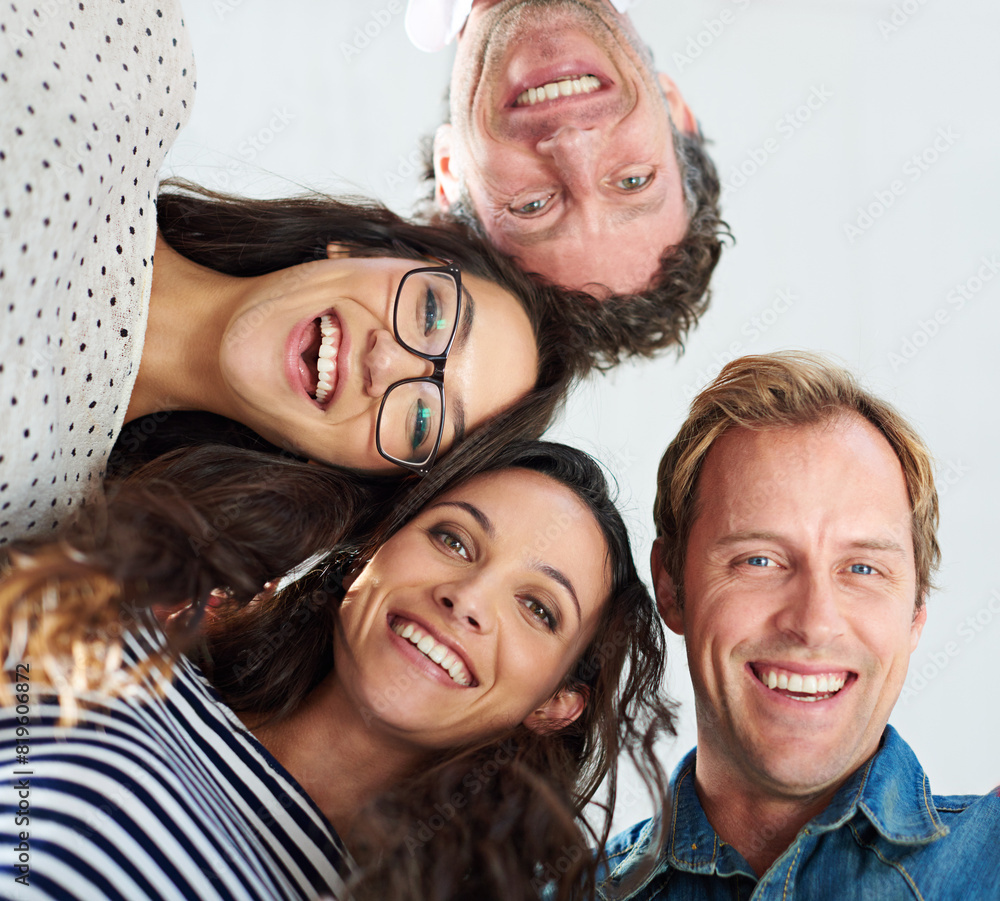 Wall mural Huddle, portrait and smile with business team in office together for solidarity or unity from below. Collaboration, employee friends and face of designer people in creative workplace for support