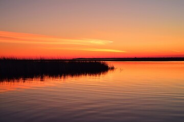 Obraz premium Vibrant Sunset Over Calm Water