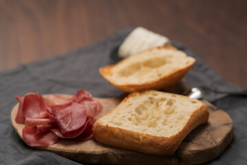 Ingredients for sandwich with bresaola, pesto and balsamic on olive board