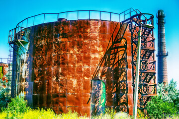 Old rusty oil tanks (fuel reservoir, oil barrel). Evidence of economic stagnation and environmental...
