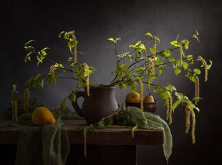 Still life with spring birch branches and decorative pumpkins on a dark background