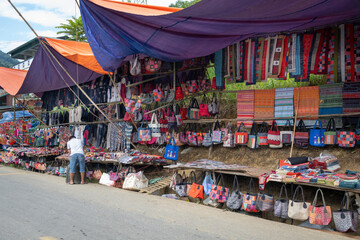 Colourful traditional items for sale at Can Cau Market in Lao Cai Province, Vietnam