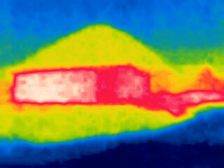 A rural area with houses in desert, barchan. Image from thermal imager device.