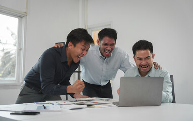 Happy team of young Asian businessmen Congratulate together and celebrate your success in starting...