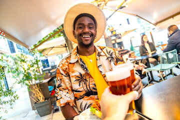 Cool brunette man toasting with friend on a terrace