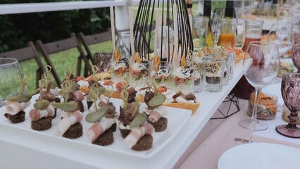 Buffet indoors. Catering business waiter. Catering on a banquet table with appetizers-canapes in a restaurant or hotel. Snacks on the table, catering concept.