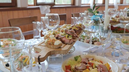 Beautifully decorated banquet table with appetizers from canapes. Business lunch. Catering on a banquet table with appetizers-canapes in a restaurant or hotel.