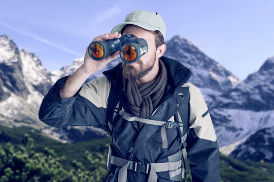 Man, hiking and binoculars on mountain snow, search and travel in winter for sightseeing in nature. Male person, watch and trekking journey in outdoor for challenge, adventure and gear for discovery