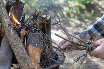 Man lights a fire in the fireplace