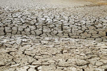 Dried soil surface, waterless sewer pipes after long time hot season at Mekong Delta, Viet Nam,...