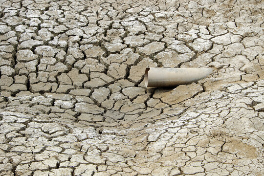Dried soil surface, waterless sewer pipes after long time hot season at Mekong Delta, Viet Nam, climate change and el nino make hard weather of global, drought field affect to food Security