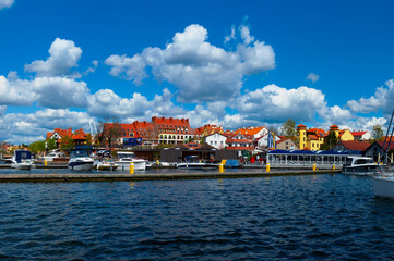 Obraz premium 2023-04-28; Lake of town, marina for yachts and boats at the waterfront. Mikolajki, Poland.