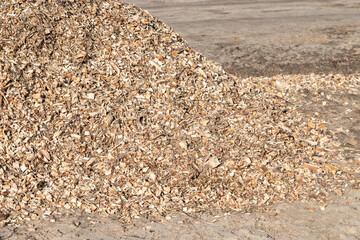 Pile of wood chips background, top view. Organic mulch. Waste from the woodworking industry, fuel...
