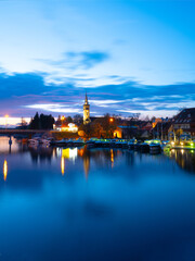 2023-04-27; panorama Mikolajskie Lake of town, marina for yachts and boats at the waterfront. Mikolajki, Poland.